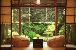 two sofa chairs with table in a room