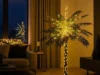 Artificial Christmas Palm Tree with 256 LED lights displayed in a modern living room